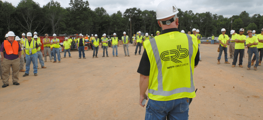 Construction safety leader on site talks to CRB team
