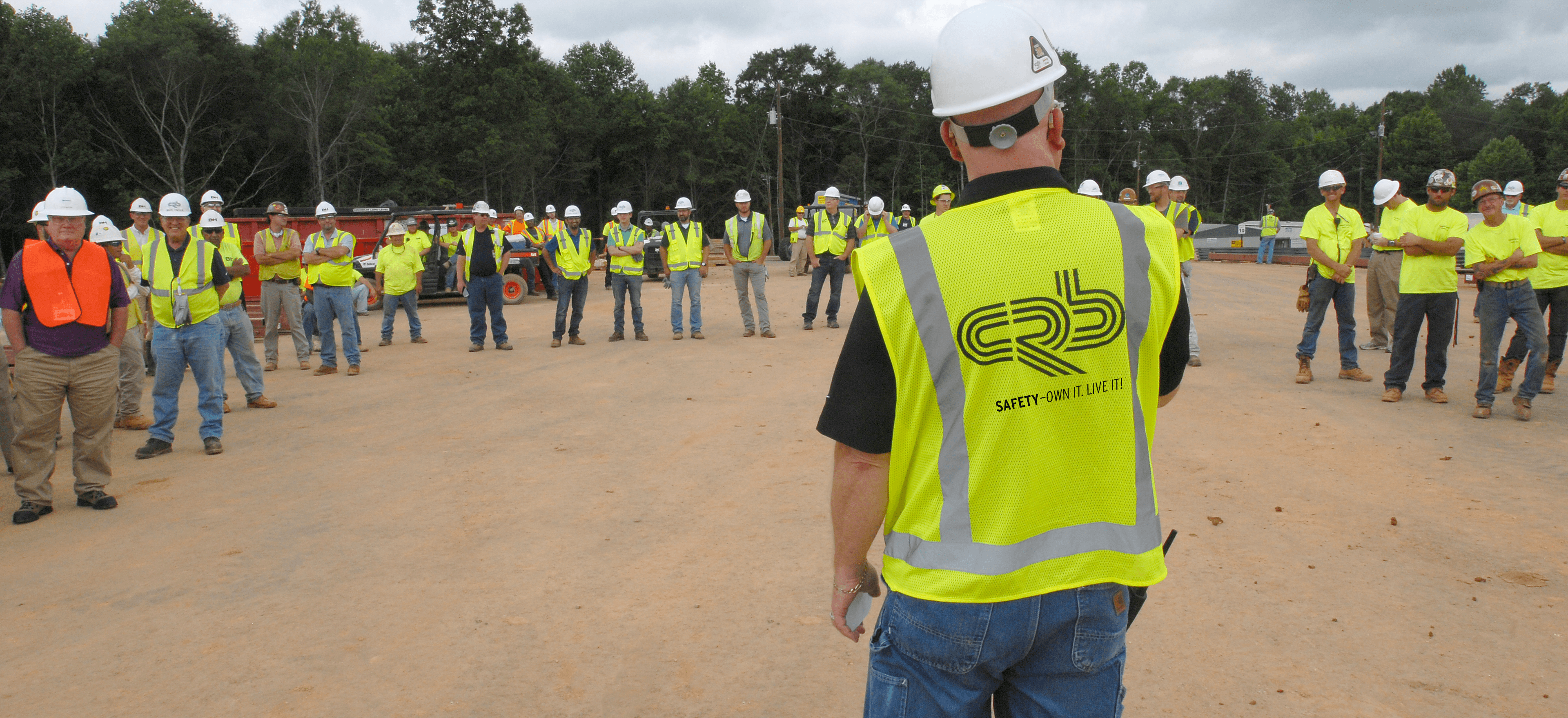 Construction safety leader on site talks to CRB team