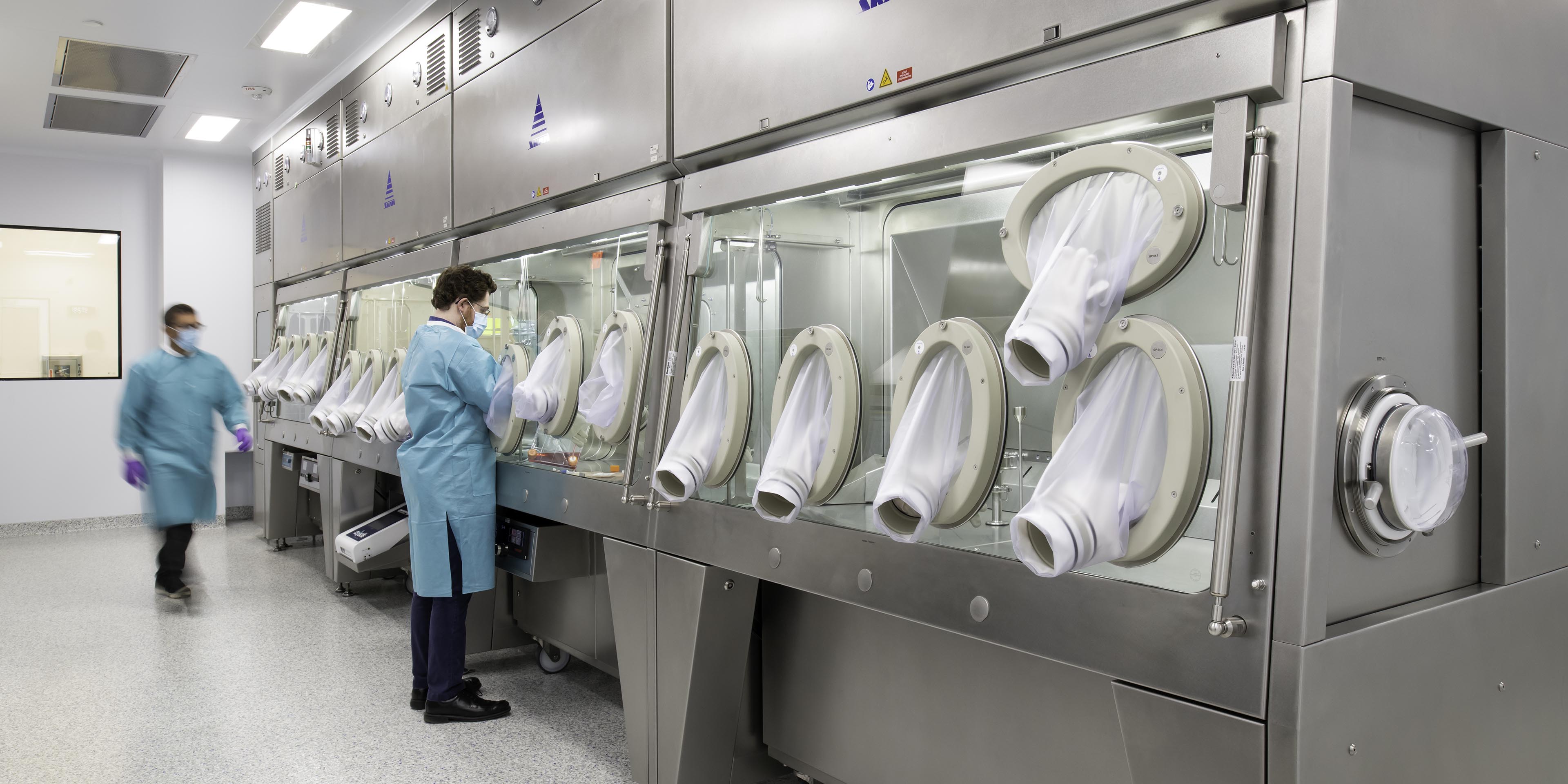 scientist using a sealed laboratory glove box