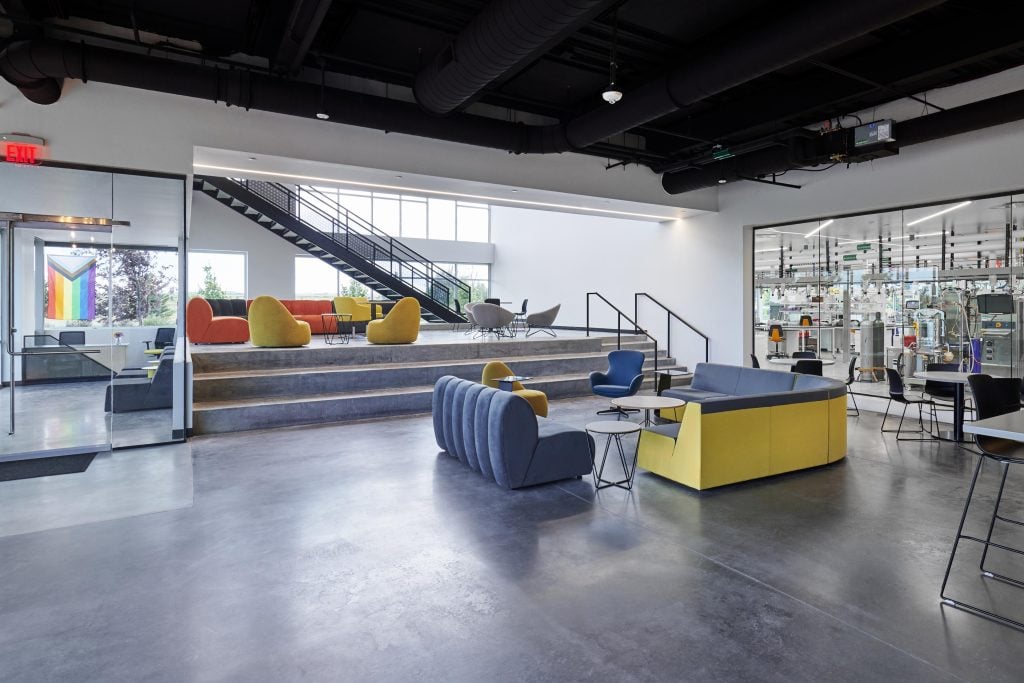 Umoja Biopharma's new ATMP facility lobby with bold colors and views of bioreactor.