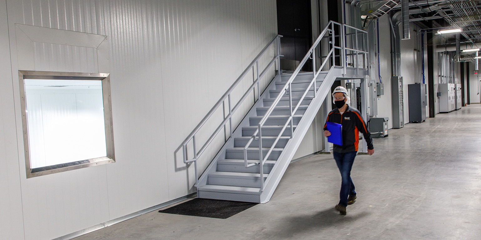 man walking in touring corridors at Tuffy’s Treat Company