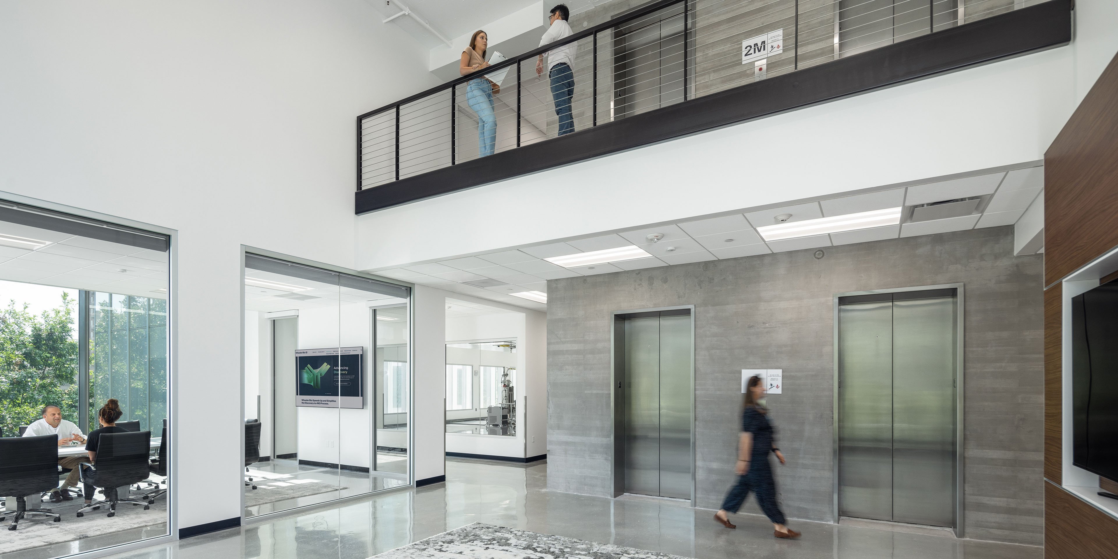 Open office space with mezzanine overlooking the lobby and conference rooms.