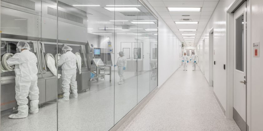 Cleanroom corridor showcasing gene therapy isolator.