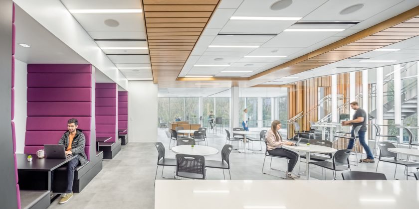 Bright, modern café space in a gene therapy facility with sleek furnishings and natural lighting for employee collaboration and relaxation.