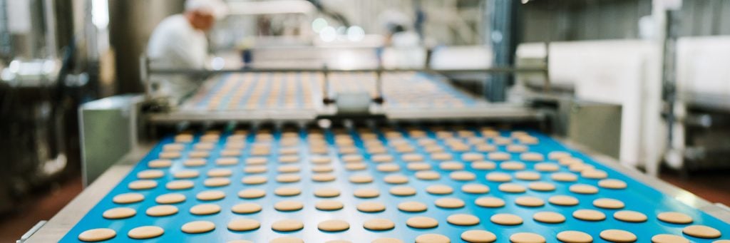 food manufacturing line with cookies and worker