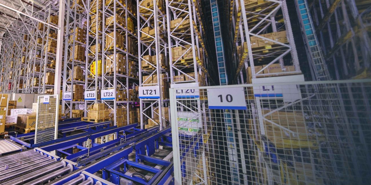 A look inside of a large, automated warehouse with material handling equipment
