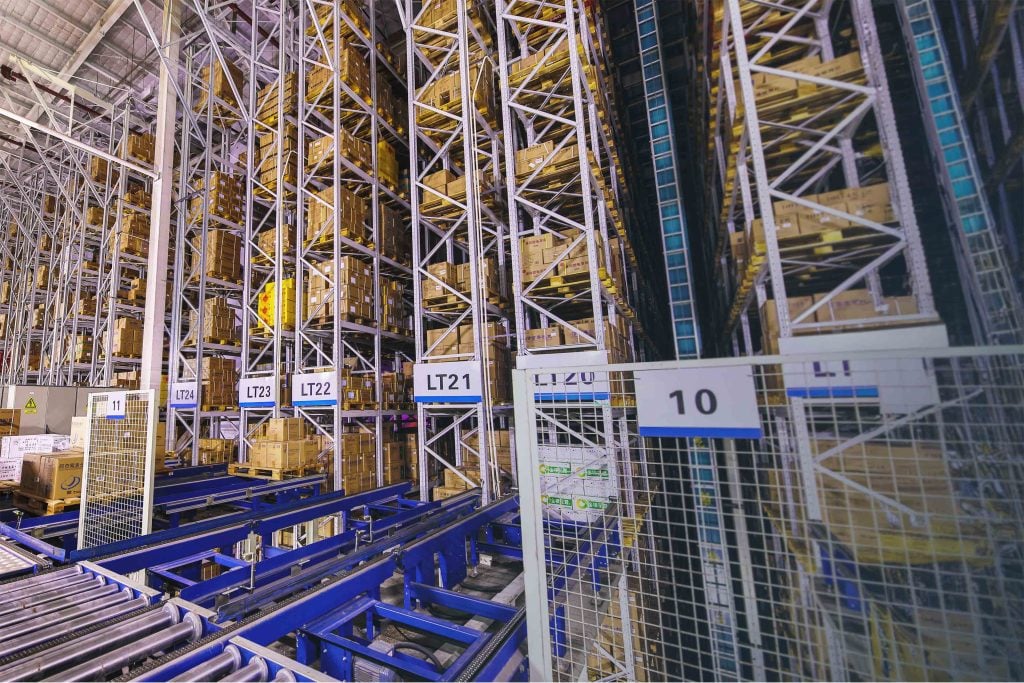 A look inside of a massive, automated warehouse with MHEs and tall racking
