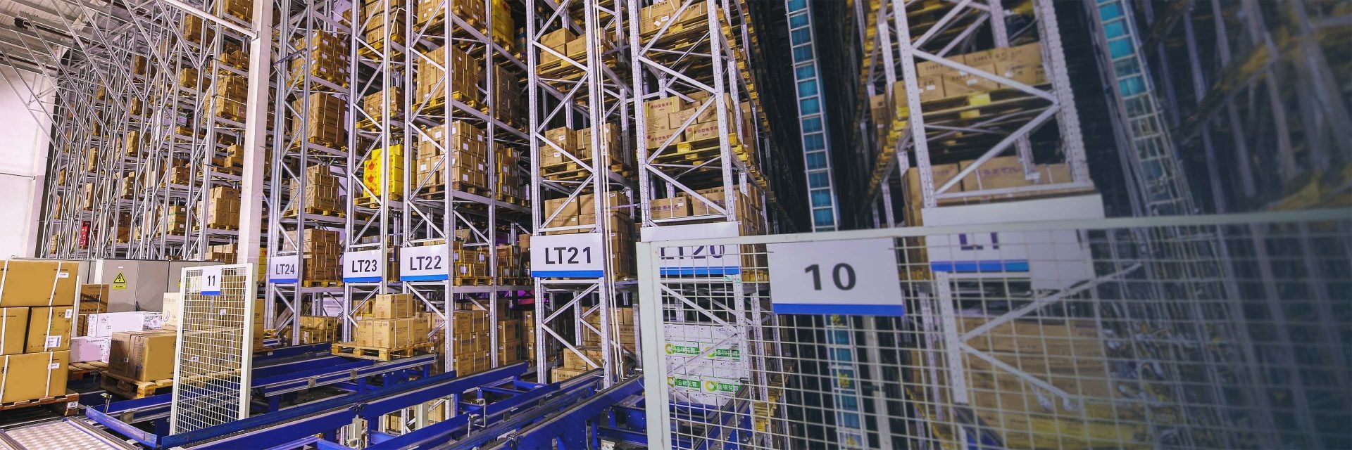 A look inside of a large, automated warehouse with MHEs