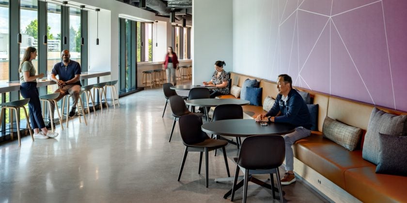 Lunch room with vibrant graphics to showcase cell therapy facility branding.